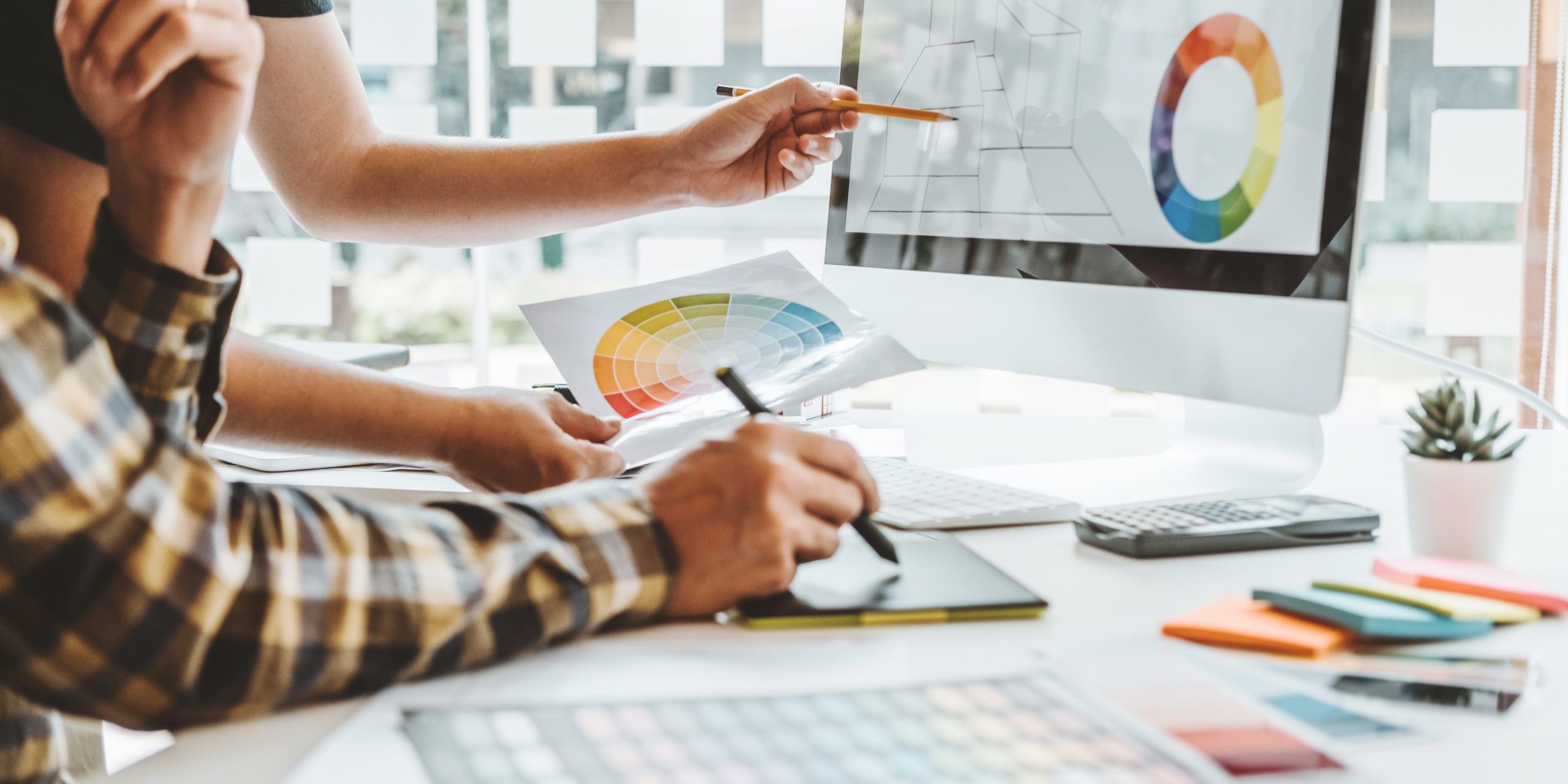 Graphic designer Brainstorming Meeting and drawing on graphics t