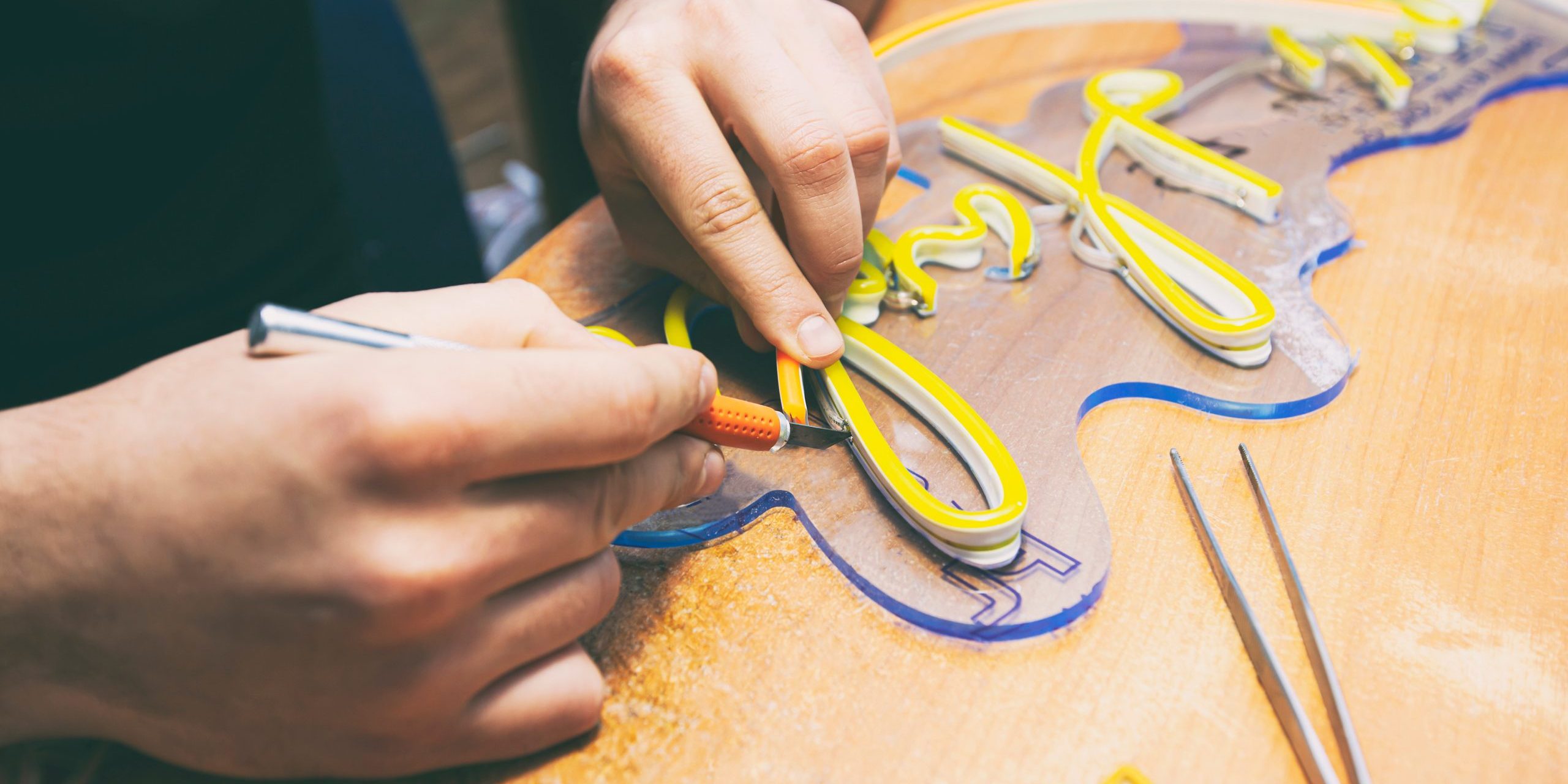 The worker is production the sign made from the led neon ribbon